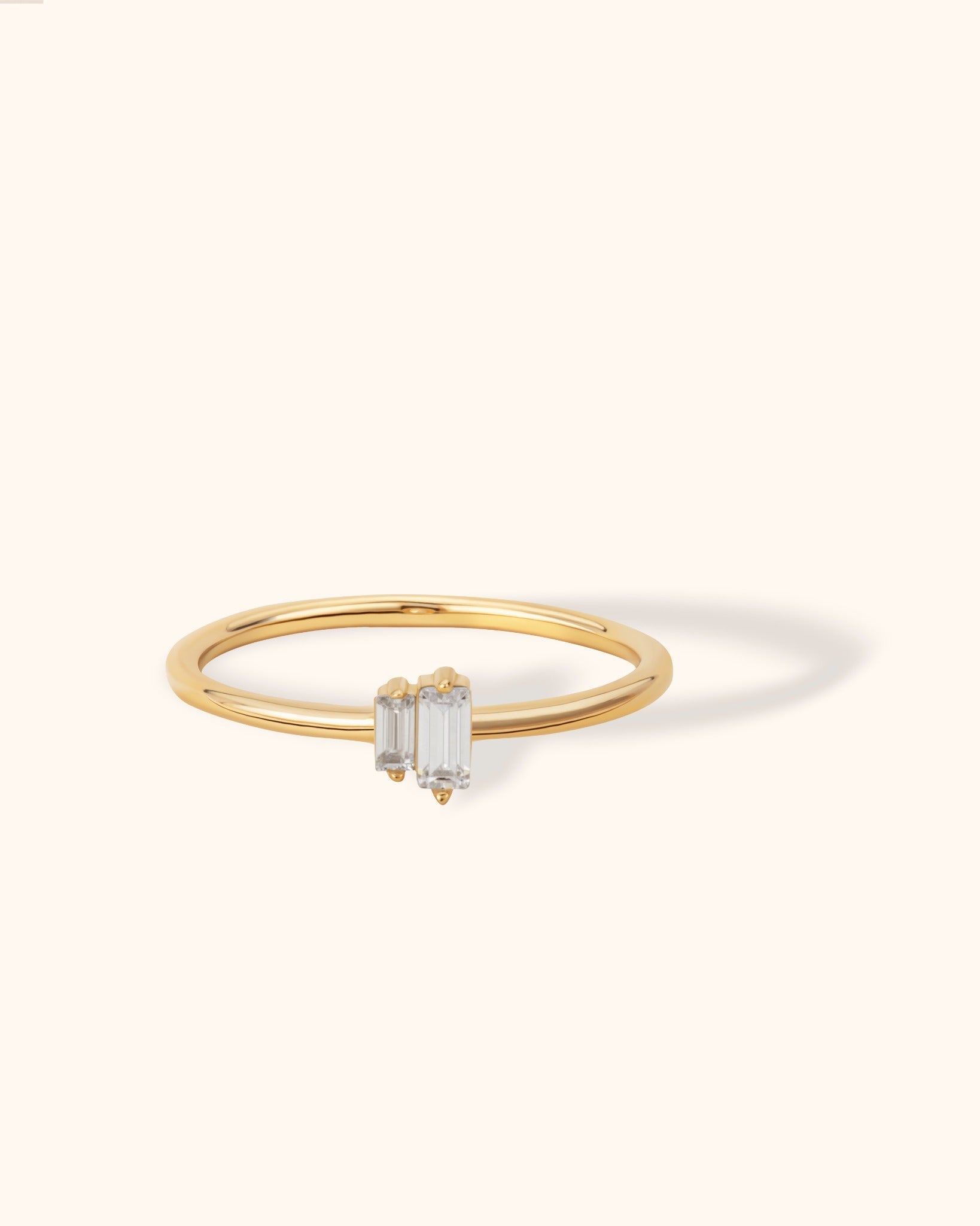 14K gold ring with two vertical baguette-cut diamonds in a minimalist open design